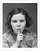1930s Portrait Of Young Girl With Finger To Mouth Making Shush Be Quiet Expression by Anonymous