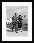 1940s Teenage Couple Walking On Suburban Sidewalk by Anonymous