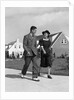 1940s Teenage Couple Walking On Suburban Sidewalk by Anonymous