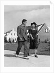 1940s Teenage Couple Walking On Suburban Sidewalk by Anonymous