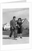 1940s Teenage Couple Walking On Suburban Sidewalk by Anonymous