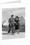 1940s Teenage Couple Walking On Suburban Sidewalk by Anonymous