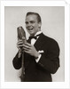1920s 1930s Man Radio Singer Entertainer Crooner In Tuxedo Singing Into Microphone by Anonymous