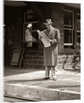 1950s Businessman On Railroad Station Platform Reading Newspaper Waiting For Train by Anonymous