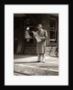 1950s Businessman On Railroad Station Platform Reading Newspaper Waiting For Train by Anonymous