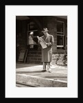 1950s Businessman On Railroad Station Platform Reading Newspaper Waiting For Train by Anonymous