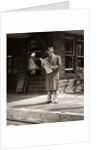 1950s Businessman On Railroad Station Platform Reading Newspaper Waiting For Train by Anonymous