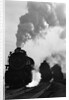 1930s 1940s Head-On View Of Three Steam Engines Silhouetted Against Billowing Smoke And Steam Outdoor by Anonymous