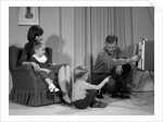 1960s Family Mother Father Son Daughter Watching Television In Living Room Indoor by Anonymous
