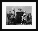 1940s Senior Couple Sitting In Living Room Reading Newspaper And Magazine Listening To Radio by Anonymous