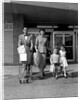 1950s Family Walking Out Of Supermarket Store by Anonymous