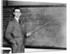 1930s Man Teacher Looking At Camera With Pointer At Blackboard by Anonymous
