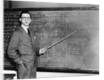 1930s Man Teacher Looking At Camera With Pointer At Blackboard by Anonymous