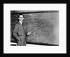 1930s Man Teacher Looking At Camera With Pointer At Blackboard by Anonymous