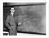 1930s Man Teacher Looking At Camera With Pointer At Blackboard by Anonymous