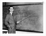 1930s Man Teacher Looking At Camera With Pointer At Blackboard by Anonymous