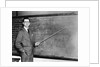 1930s Man Teacher Looking At Camera With Pointer At Blackboard by Anonymous