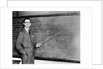 1930s Man Teacher Looking At Camera With Pointer At Blackboard by Anonymous