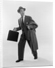 1950s Surprised Businessman Holding Briefcase Taking A Step Forward Looking Back by Anonymous