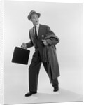 1950s Surprised Businessman Holding Briefcase Taking A Step Forward Looking Back by Anonymous