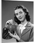 1940s Woman Putting Change Into Piggy Bank by Anonymous