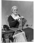 1930s Elderly Woman Wearing Pince-Nez Glasses Sitting Knitting by Anonymous