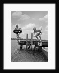 1940s 1950s Two Boys Wearing Inflatable Inner Tubes About To Jump In Lake Off Pier by Anonymous