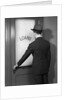 1930s 1940s Man In Suit And Hat Opening Door Marked Loans by Anonymous