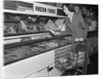 1950s Woman Shopping Frozen Food Section Of Grocery Store by Anonymous
