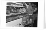 1950s Woman Shopping Frozen Food Section Of Grocery Store by Anonymous