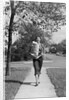 1950s Woman Walking On Sidewalk Carrying A Grocery Bag Full Of Food by Anonymous