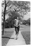 1950s Woman Walking On Sidewalk Carrying A Grocery Bag Full Of Food by Anonymous
