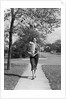 1950s Woman Walking On Sidewalk Carrying A Grocery Bag Full Of Food by Anonymous