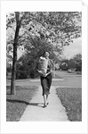 1950s Woman Walking On Sidewalk Carrying A Grocery Bag Full Of Food by Anonymous