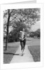 1950s Woman Walking On Sidewalk Carrying A Grocery Bag Full Of Food by Anonymous