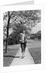 1950s Woman Walking On Sidewalk Carrying A Grocery Bag Full Of Food by Anonymous
