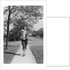 1950s Woman Walking On Sidewalk Carrying A Grocery Bag Full Of Food by Anonymous