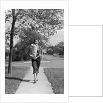 1950s Woman Walking On Sidewalk Carrying A Grocery Bag Full Of Food by Anonymous