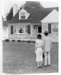 1940s 1950s Couple Standing Outside Looking At Stone Suburban House by Anonymous