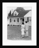 1940s 1950s Couple Standing Outside Looking At Stone Suburban House by Anonymous