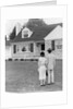 1940s 1950s Couple Standing Outside Looking At Stone Suburban House by Anonymous