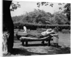1950s Elderly Man In Backyard Stretched Out On Lounge Chair Under Tree by Anonymous