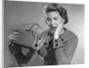 1950s Woman With Exaggerated Expression Hand On Face Looking Inside Her Purse by Anonymous