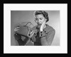 1950s Woman With Exaggerated Expression Hand On Face Looking Inside Her Purse by Anonymous