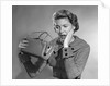 1950s Woman With Exaggerated Expression Hand On Face Looking Inside Her Purse by Anonymous