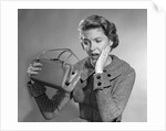 1950s Woman With Exaggerated Expression Hand On Face Looking Inside Her Purse by Anonymous