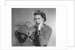 1950s Woman With Exaggerated Expression Hand On Face Looking Inside Her Purse by Anonymous