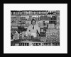 1940s Grocer Standing Behind Counter Filled With Various Food Products by Anonymous