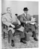 1950s 1960s Two Men Businessman Salesman Sitting In Office Reception Waiting Area Indoor by Anonymous