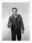 1960s Salesman Or Businessman Leaning Forward Extending Hand For Handshake by Anonymous